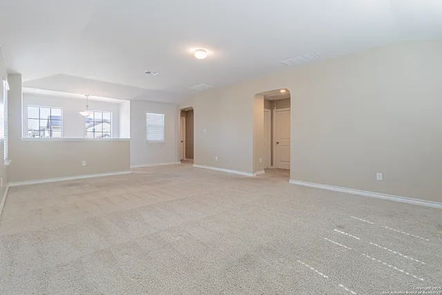an empty room with windows and closet