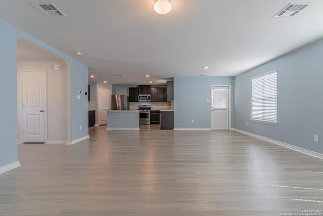 a view of kitchen with furniture and wooden floor