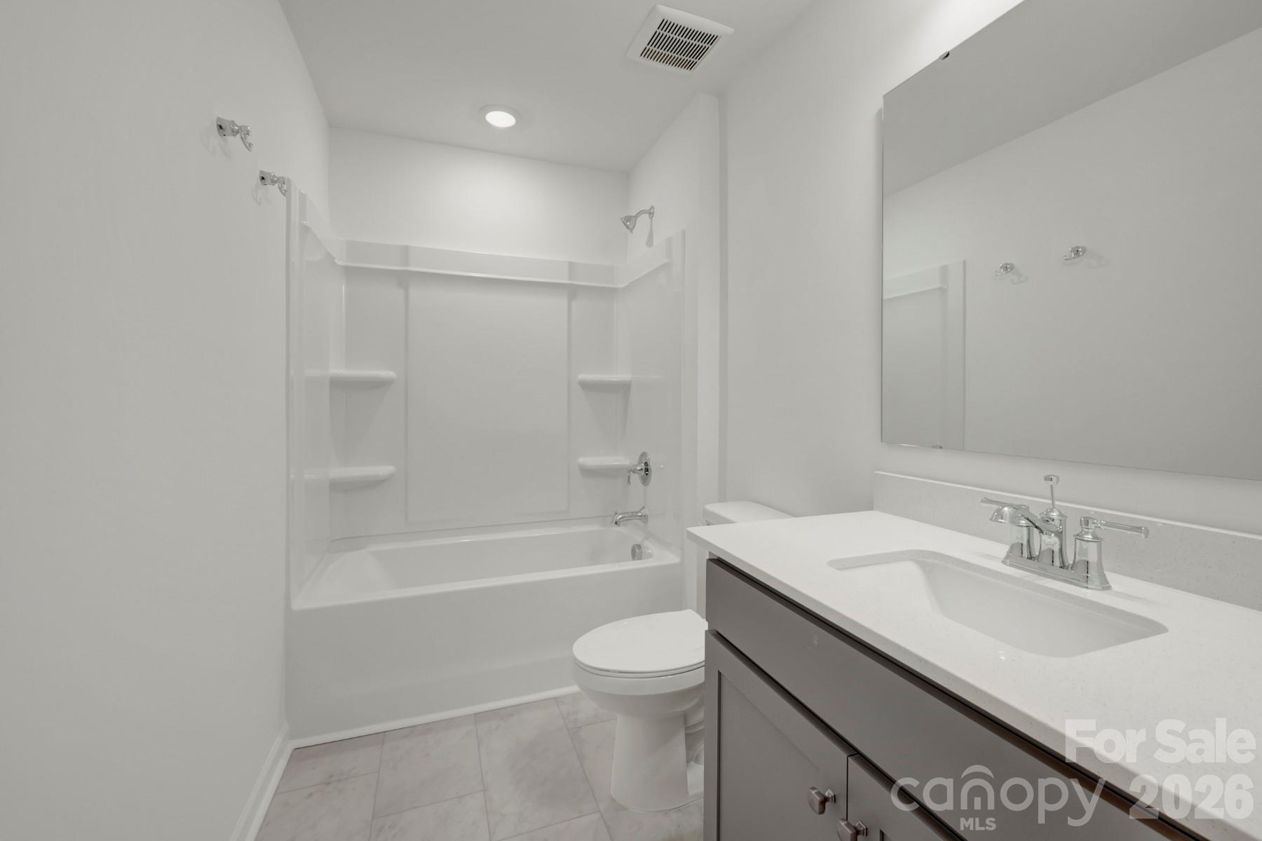 1138 Overbrook Place Wingate, NC 28174 - Photo 15 of 22 a bathroom with a granite countertop sink a toilet and shower