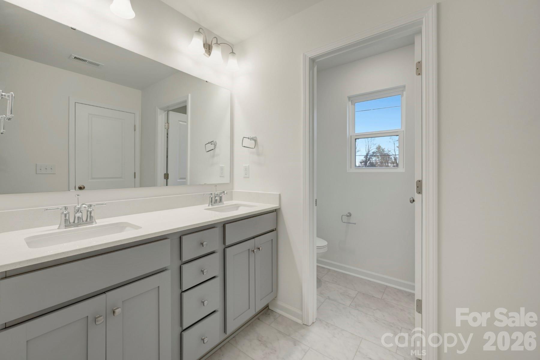 1138 Overbrook Place Wingate, NC 28174 - Photo 22 of 22 a bathroom with a double vanity sink and mirror