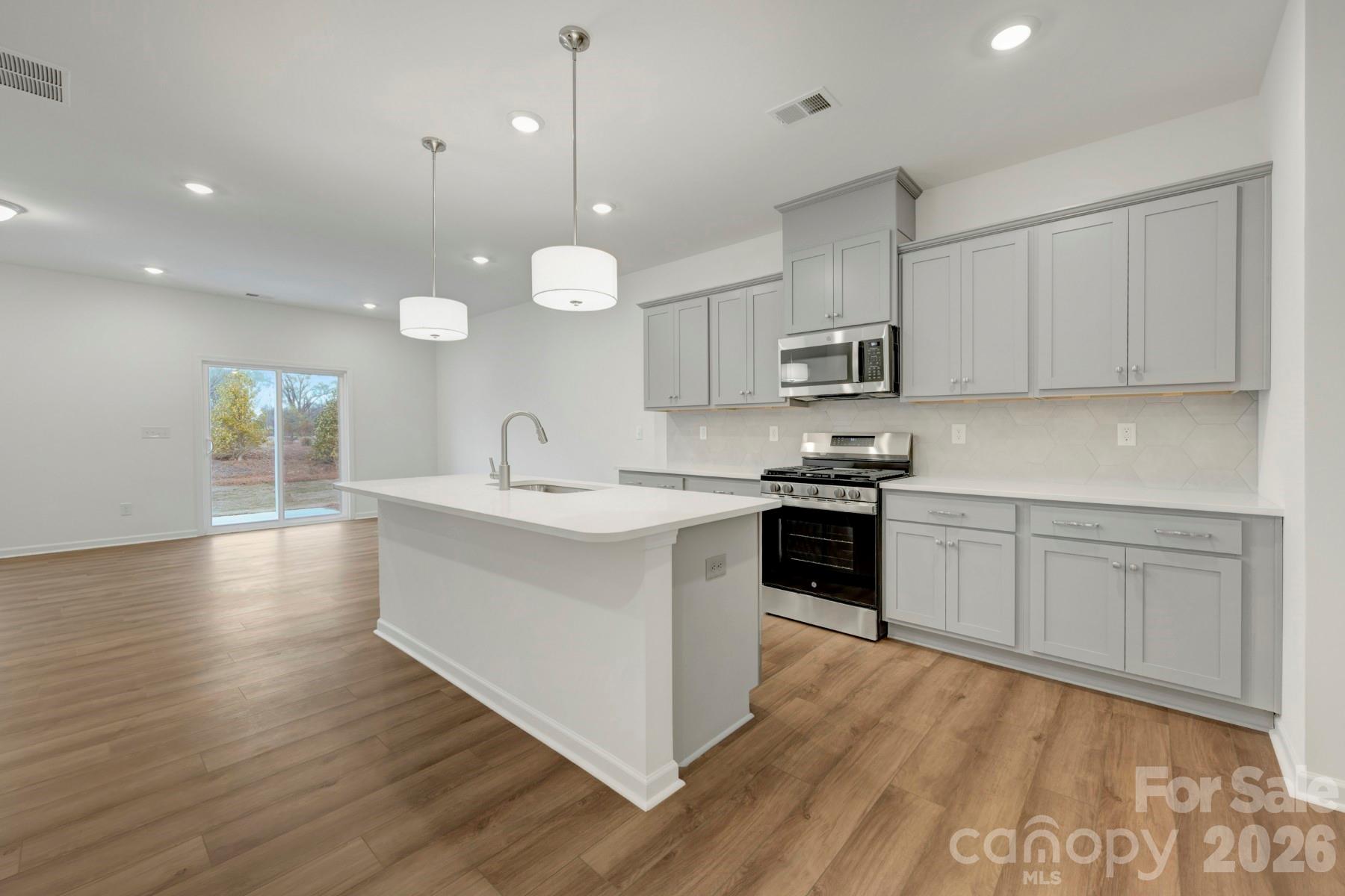 1138 Overbrook Place Wingate, NC 28174 - Photo 3 of 22 a kitchen with a sink stove top oven and cabinets