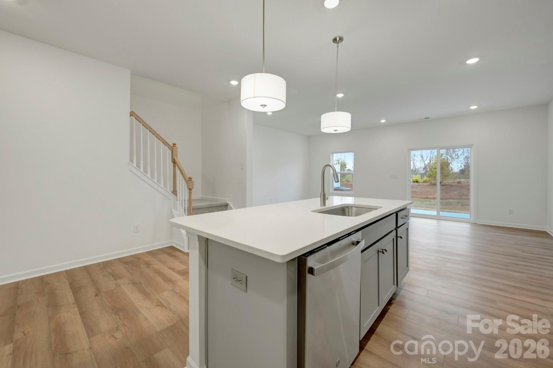 1138 Overbrook Place Wingate, NC 28174 - Photo 5 of 22 a kitchen with a sink a chandelier stainless steel appliances and cabinets