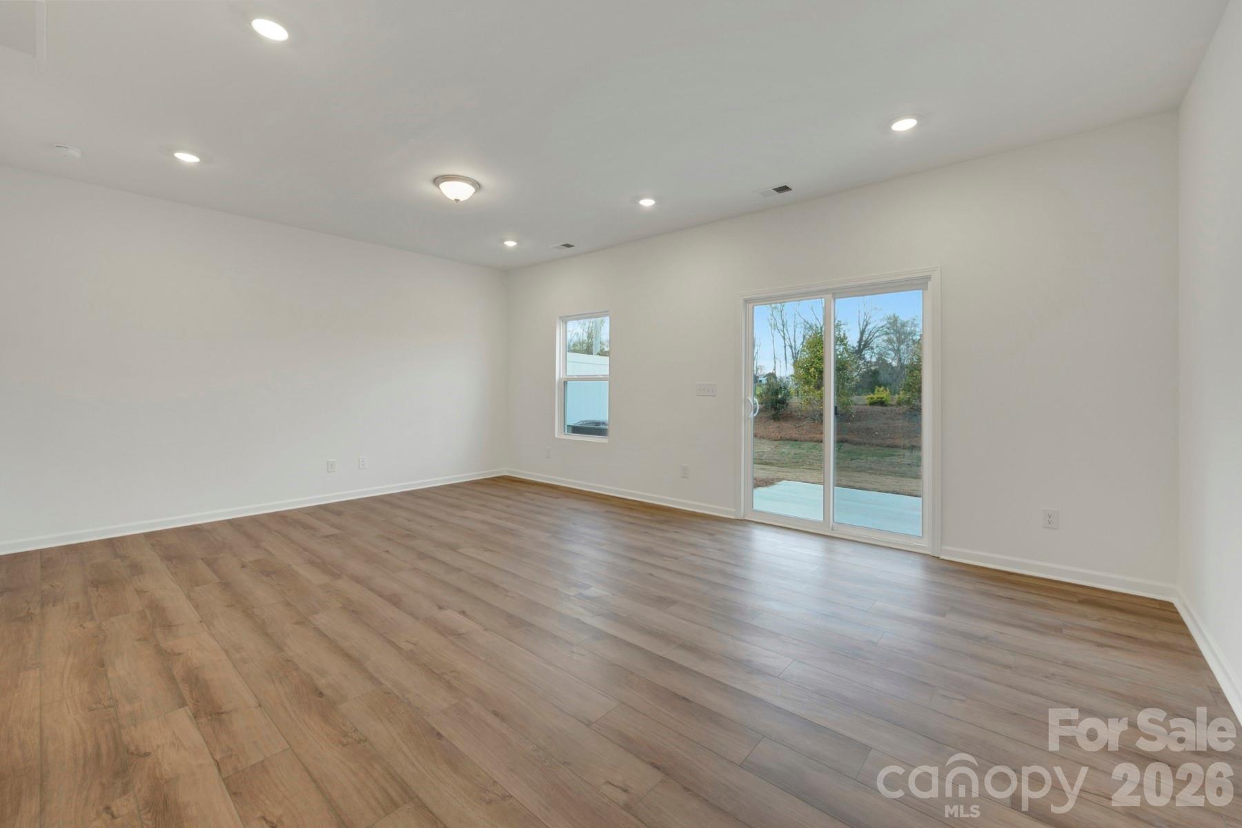 1138 Overbrook Place Wingate, NC 28174 - Photo 7 of 22 an empty room with wooden floor and windows