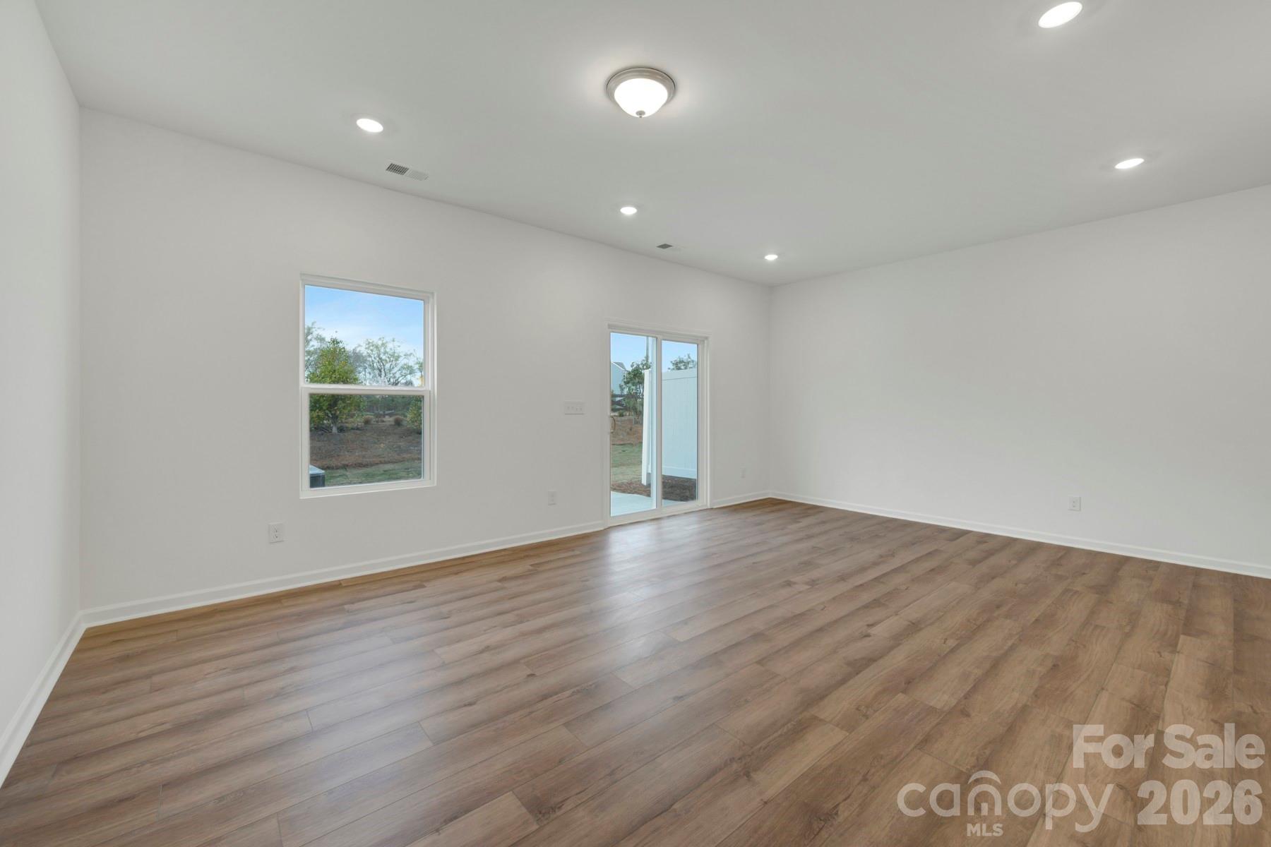 1138 Overbrook Place Wingate, NC 28174 - Photo 10 of 22 an empty room with wooden floor and windows