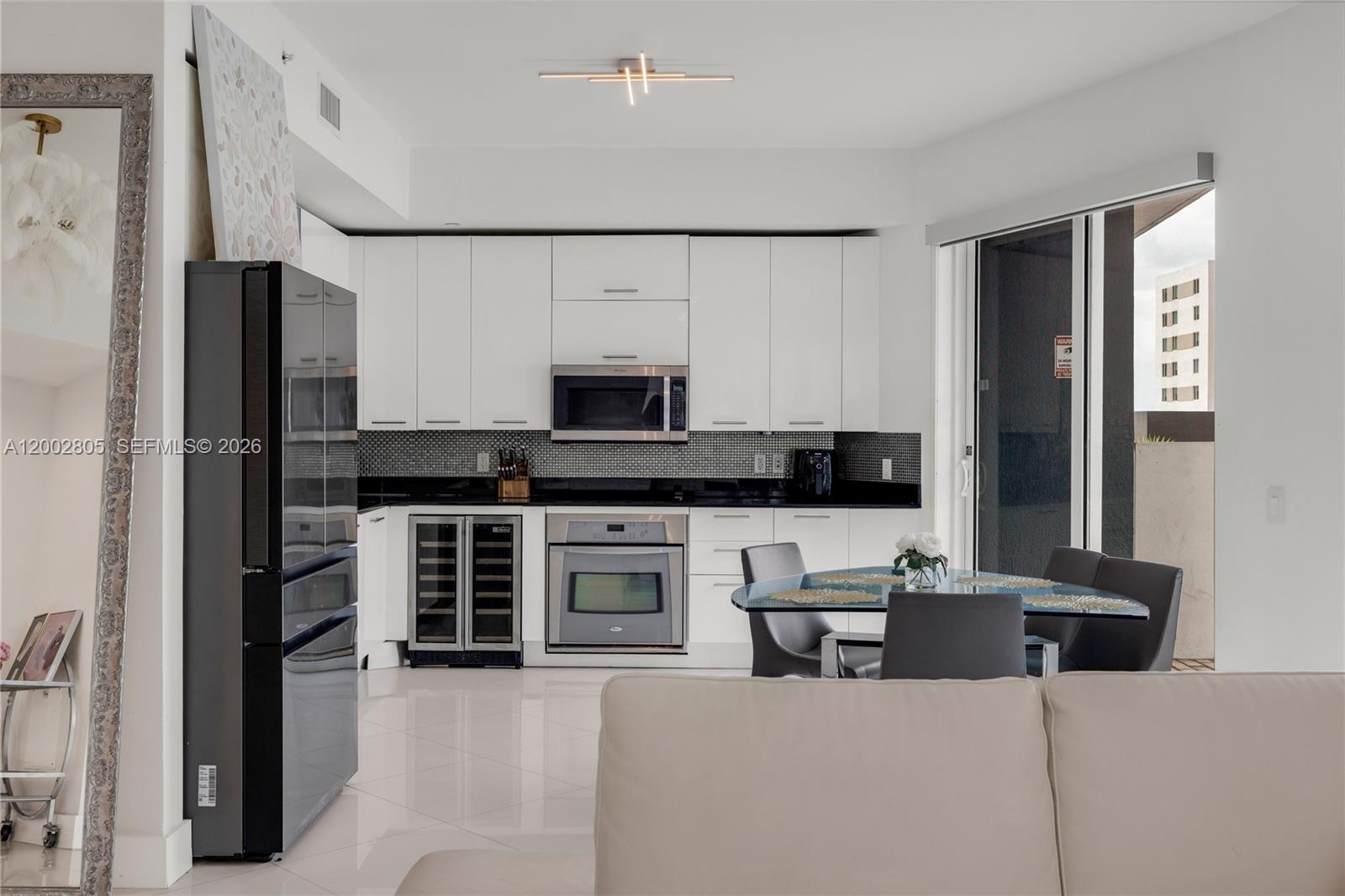 60 Southwest 13th Street, Unit 1124 Miami, FL 33130 - Photo 9 of 30 a kitchen with stainless steel appliances a stove refrigerator and a sink