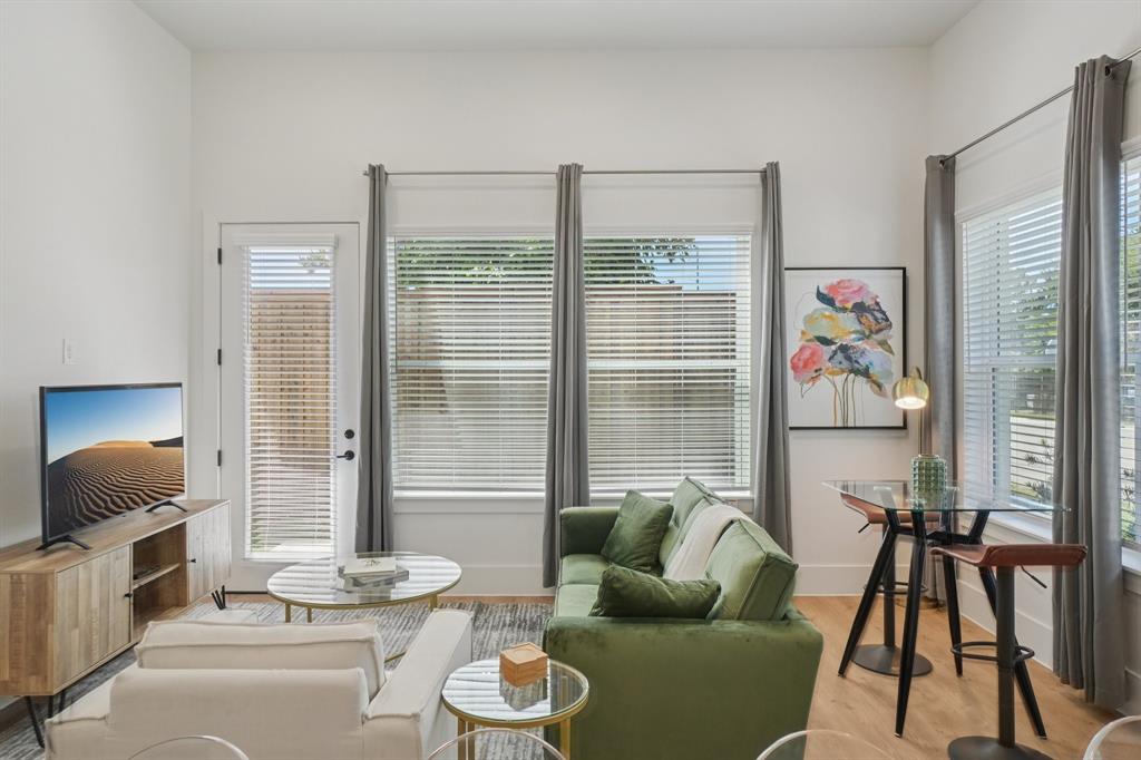 6418 Maple Avenue, Unit 307 Dallas, TX 75235 - Photo 7 of 16 a living room with furniture and a floor to ceiling window