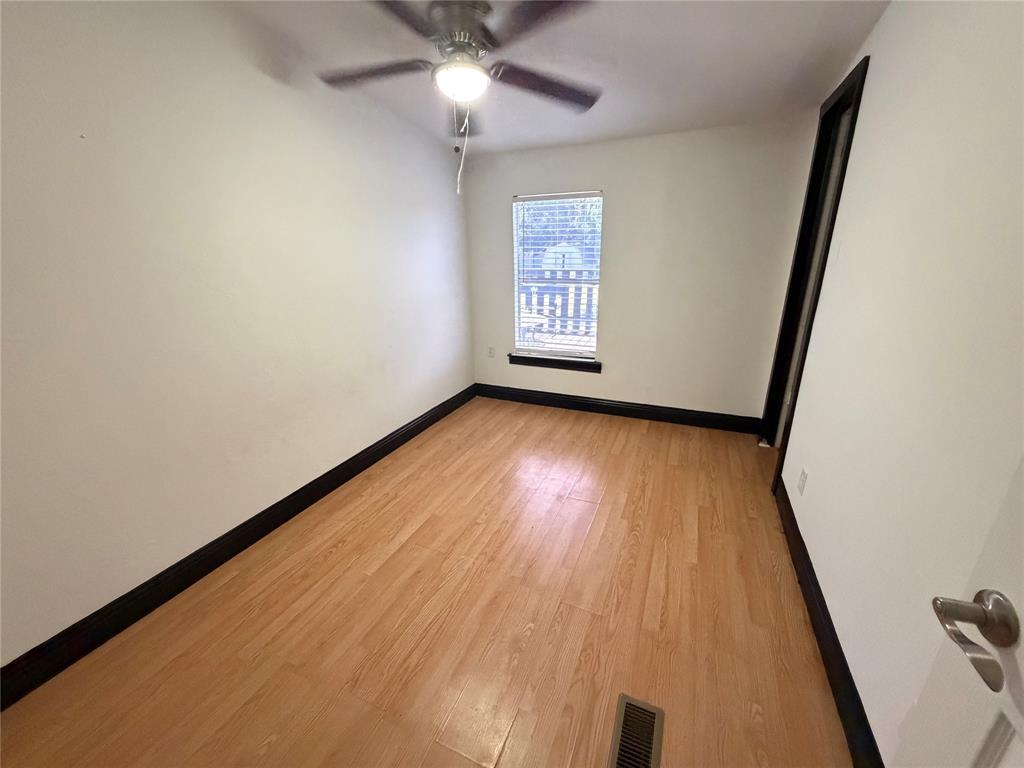 222 Hix Road Cleburne, TX 76031 - Photo 14 of 27 an empty room with wooden floor fan and windows