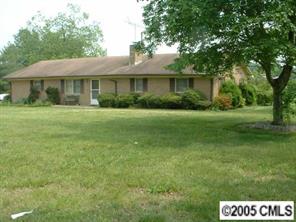 5403 Griffith Road Monroe, NC 28112 - Photo 1 of 3 a front view of a house with a garden
