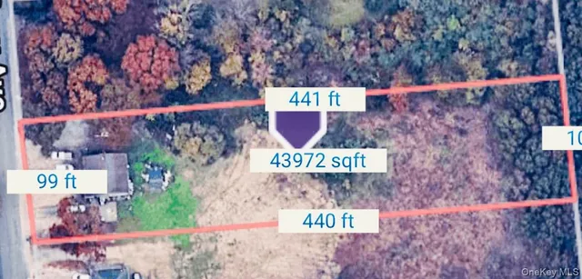 a street sign on a wall next to a road