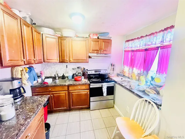 a kitchen with stainless steel appliances a sink window and cabinets