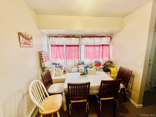a view of a dining room with furniture and a window