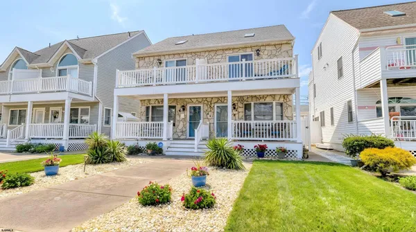 a front view of a house with swimming pool and porch