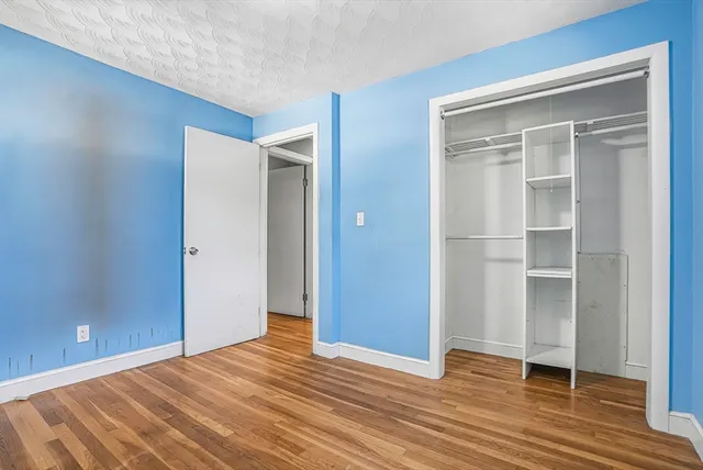 a kitchen with granite countertop white cabinets stainless steel appliances a sink and a window