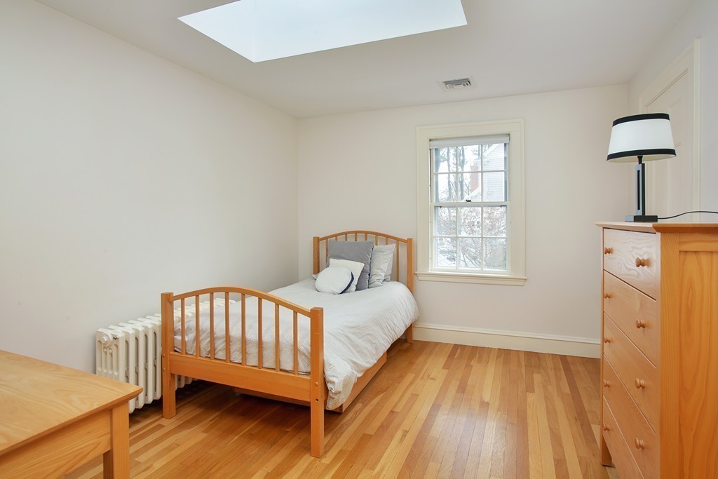 14 Pilgrim Road Wellesley, MA 02481 - Photo 17 of 20 a bedroom with a bed and wooden floor