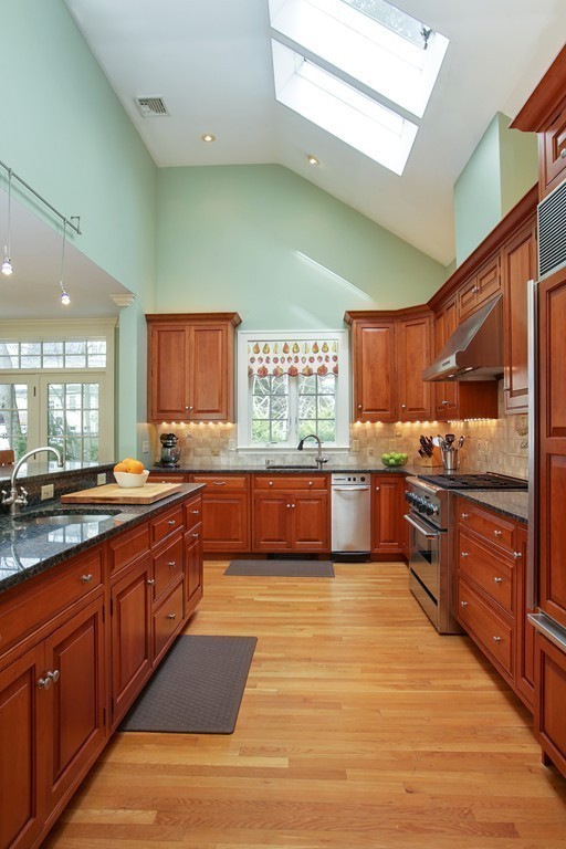14 Pilgrim Road Wellesley, MA 02481 - Photo 8 of 20 a large kitchen with wooden cabinets and stainless steel appliances