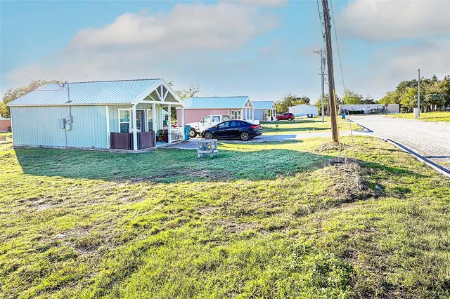 a view of an house with backyard and patio