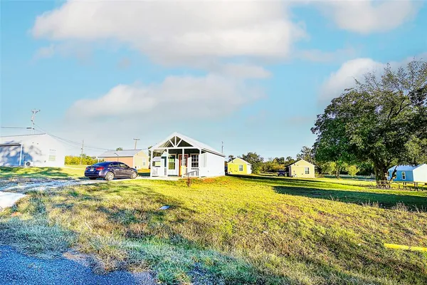 a view of a house with a yard and sitting area
