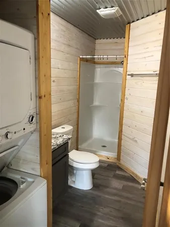 a bathroom with a toilet and a shower