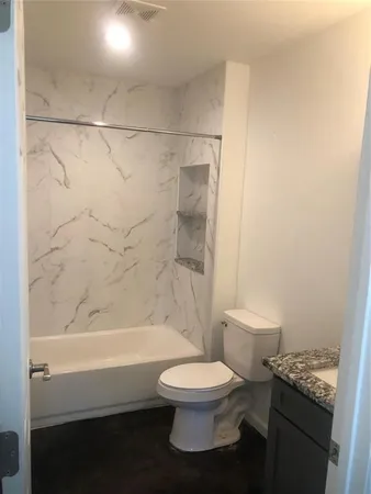a bathroom with a toilet and a bathtub