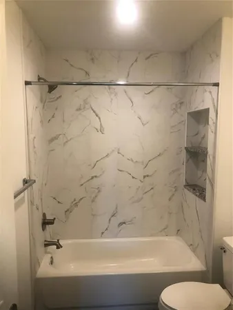 a bathroom with a bathtub and a shower