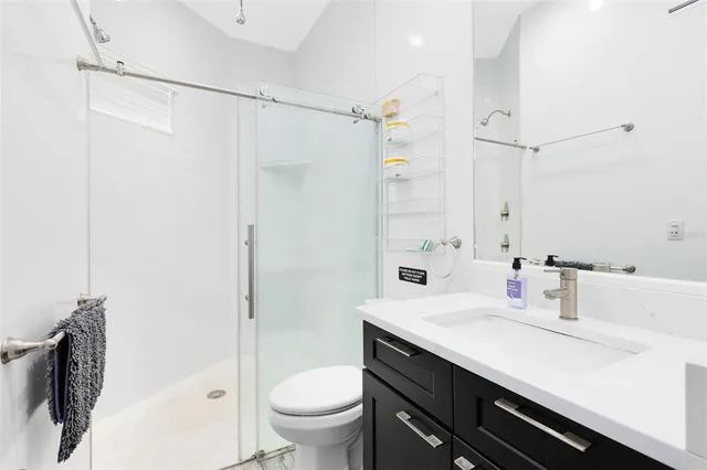 a bathroom with a sink toilet and shower