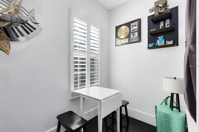 a view of a workspace with furniture and a window