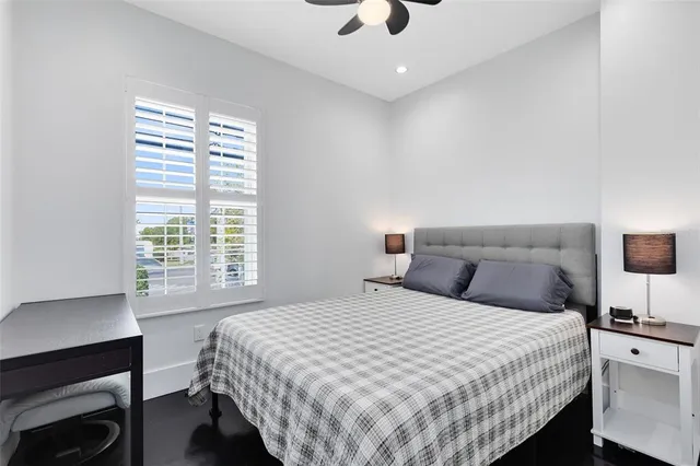 a bedroom with a large bed and a desk