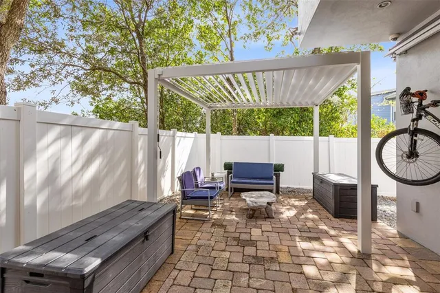 a backyard of a house with barbeque oven table and chairs