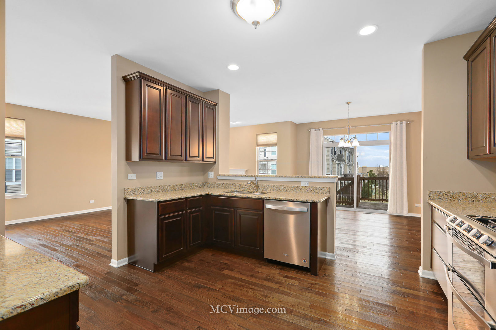 2959 Church Road Aurora, IL 60502 - Photo 14 of 36 a large kitchen with granite countertop a stove and a sink