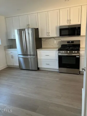 a kitchen with a stove microwave and refrigerator