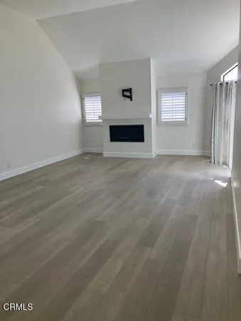 a view of empty room with window and fireplace
