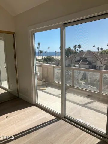 a bedroom with a large window and a bed