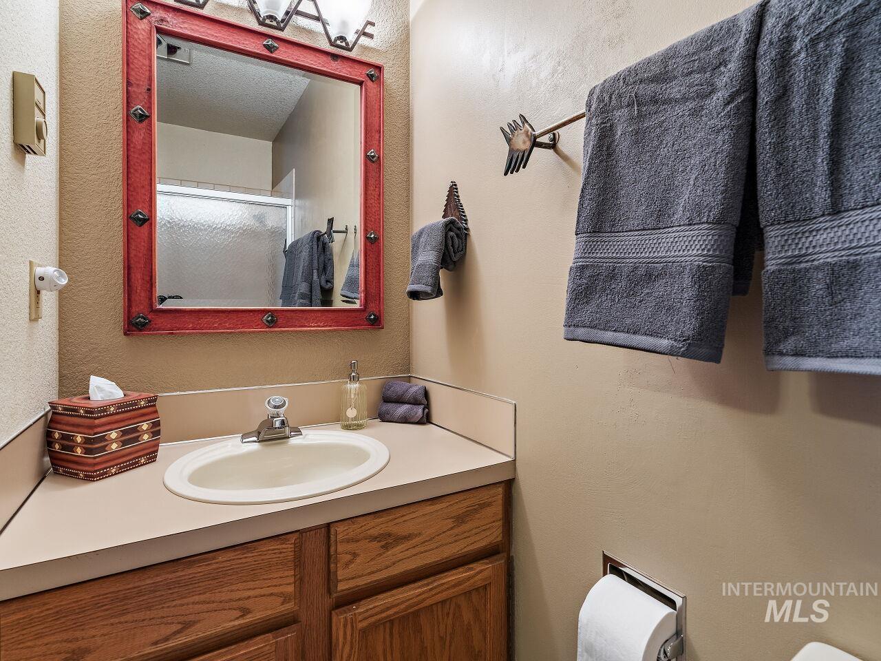 601 Hemlock Street, Unit 10 McCall, ID 83638 - Photo 30 of 43 Bathroom featuring vanity and a shower with shower door