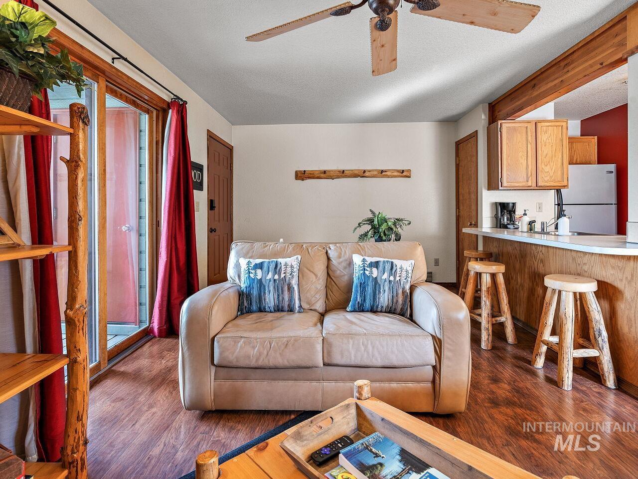 601 Hemlock Street, Unit 10 McCall, ID 83638 - Photo 31 of 43 Living room with ceiling fan, dark wood-style floors, and a textured ceiling