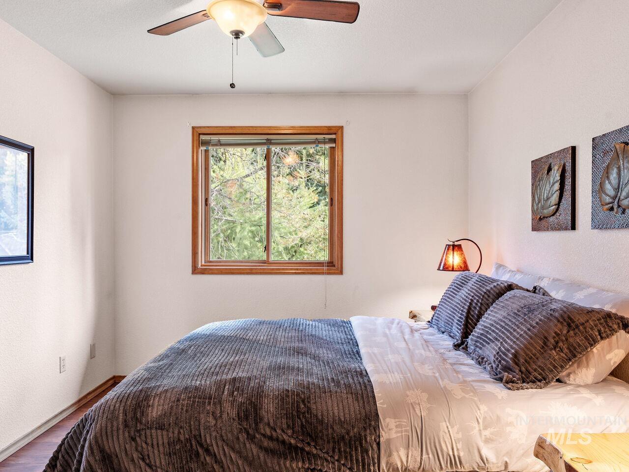 601 Hemlock Street, Unit 10 McCall, ID 83638 - Photo 34 of 43 Bedroom featuring wood finished floors and ceiling fan