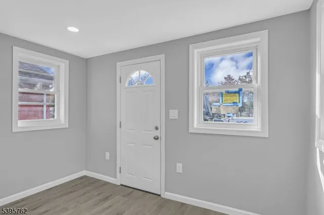 an empty room with window and furniture