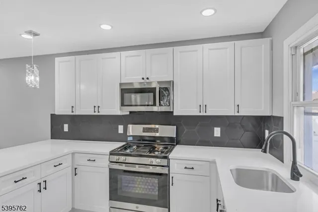 a kitchen with cabinets appliances and a sink
