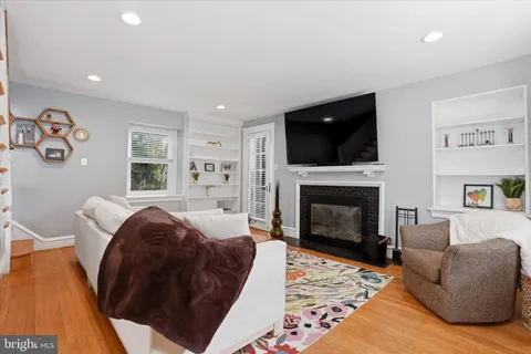 a living room with a couch a flat screen tv and a fireplace