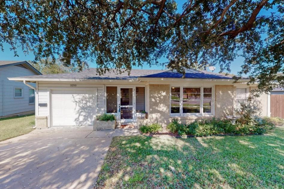 a front view of a house with garden and porch