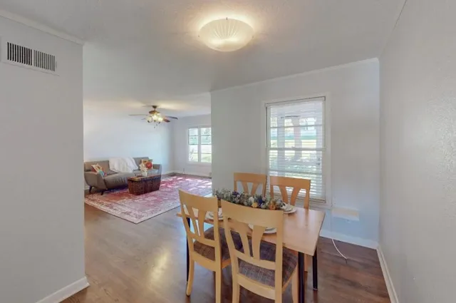 a view of a dining room with furniture and wooden floor