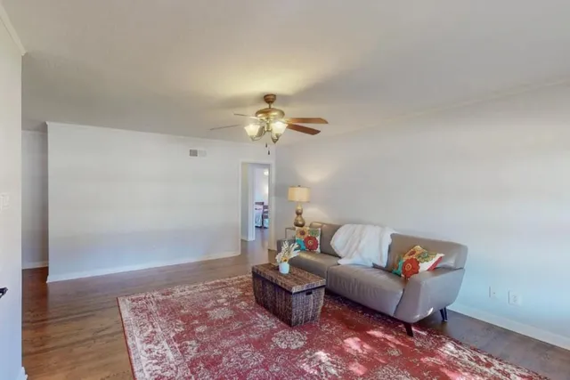 a living room with furniture and a chandelier