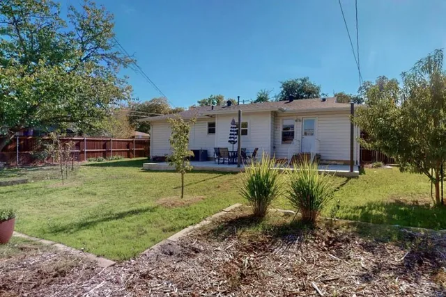 a view of a house with a yard patio and swimming pool