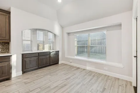 a room with a window and wooden floor