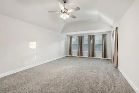 a view of a big room with chandelier fan and windows