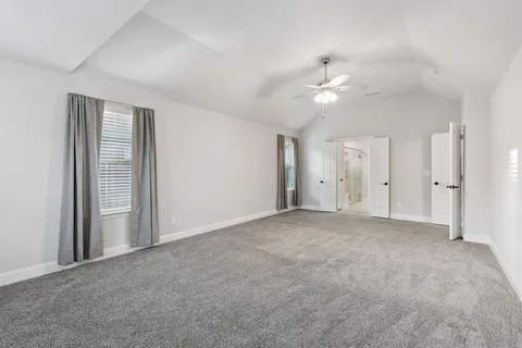 an empty room with fan and entrance