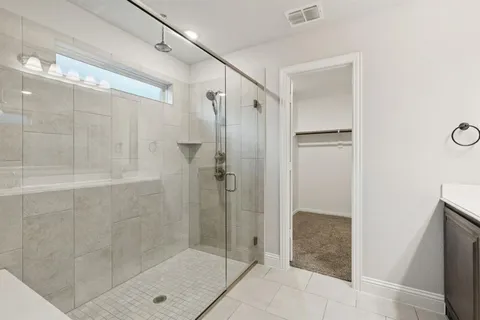 a bathroom with a shower and a sink
