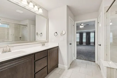a bathroom with a sink double vanity and a mirror