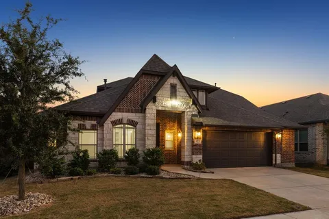 a front view of a house with lots of trees