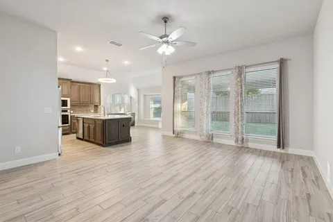 a view of a kitchen with wooden floor and a kitchen