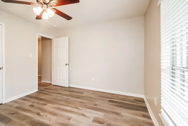 wooden floor in an empty room with a window